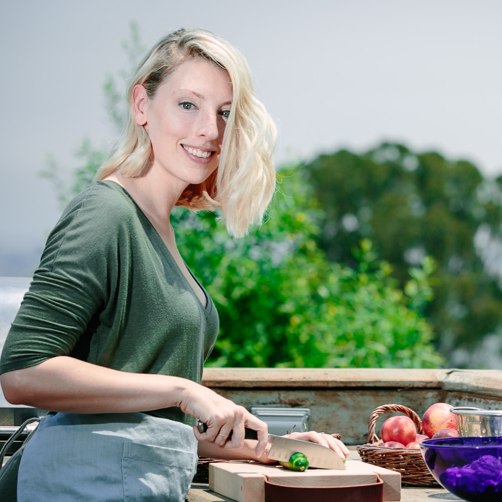 克里斯汀娜·托迪尼，Fork in the Ro欧宝不给提款ad的注册营养师，在户外厨房切蔬菜。
